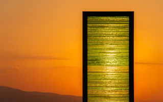 The Gate sculpture by Kostas Varotsos glowing at sunset in Aegina port Greece Aegina port, Greece, Kostas Varotsos, The Gate sculpture, architecture, glass sculpture, harbor, landmark, modern art, sunset