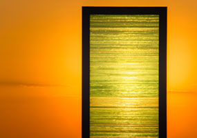 The Gate sculpture by Kostas Varotsos glowing at sunset in Aegina port Greece Aegina port, Greece, Kostas Varotsos, The Gate sculpture, architecture, glass sculpture, harbor, landmark, modern art, sunset
