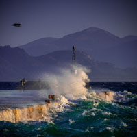 Storm at the harbor Aegina harbor, stormy sea, Mediterranean atmosphere, dramatic clouds, Greek coastline, moody seascape
