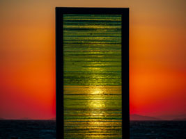 The Gate sculpture by Kostas Varotsos glowing at sunset in Aegina port Greece Aegina port, Greece, Kostas Varotsos, The Gate sculpture, architecture, glass sculpture, harbor, landmark, modern art, sunset